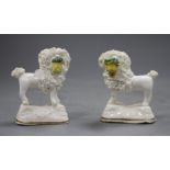 A pair of Staffordshire porcelain models of a poodle with a basket in its mouth, C.1835-50,