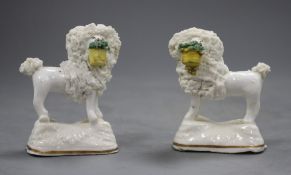 A pair of Staffordshire porcelain models of a poodle with a basket in its mouth, C.1835-50,