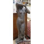 A bronze garden statue modelled a classical maiden, standing beside a tree stump, H.115cm Condition: