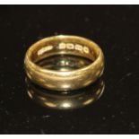 A George V 22ct gold wedding band, size N, weight 8.9 grams. Condition: Minor nicks and scratches.
