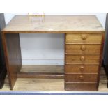A Gordon Russell teak desk, with single tier of five drawers, W.107cm D.60cm H.77cm Condition: