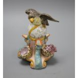 An early 19th century Staffordshire inkwell, modelled with an eagle perched upon a globe above three