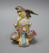 An early 19th century Staffordshire inkwell, modelled with an eagle perched upon a globe above three