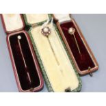 Three assorted yellow metal and gem set stick pins, including early 20th century, cultured pearl,