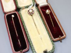 Three assorted yellow metal and gem set stick pins, including early 20th century, cultured pearl,