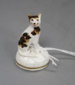 A rare Staffordshire porcelain toy figure of a seated tortoiseshell cat, c.1835-50, fine crazing
