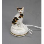 A rare Staffordshire porcelain toy figure of a seated tortoiseshell cat, c.1835-50, fine crazing