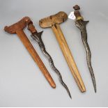 An Indonesian dagger kris, 19th century, wavy watered steel blade 35cms, carved wooden hilt and