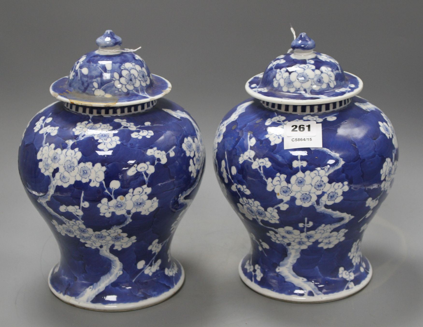 A pair of late 19th century Chinese prunus pattern baluster vases and covers, height 29cm Condition: