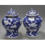 A pair of late 19th century Chinese prunus pattern baluster vases and covers, height 29cm Condition: