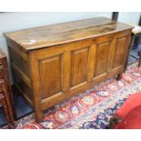 An 18th century oak panelled coffer, W.140cm D.53cm H.78cm Condition: The top horizontal joints