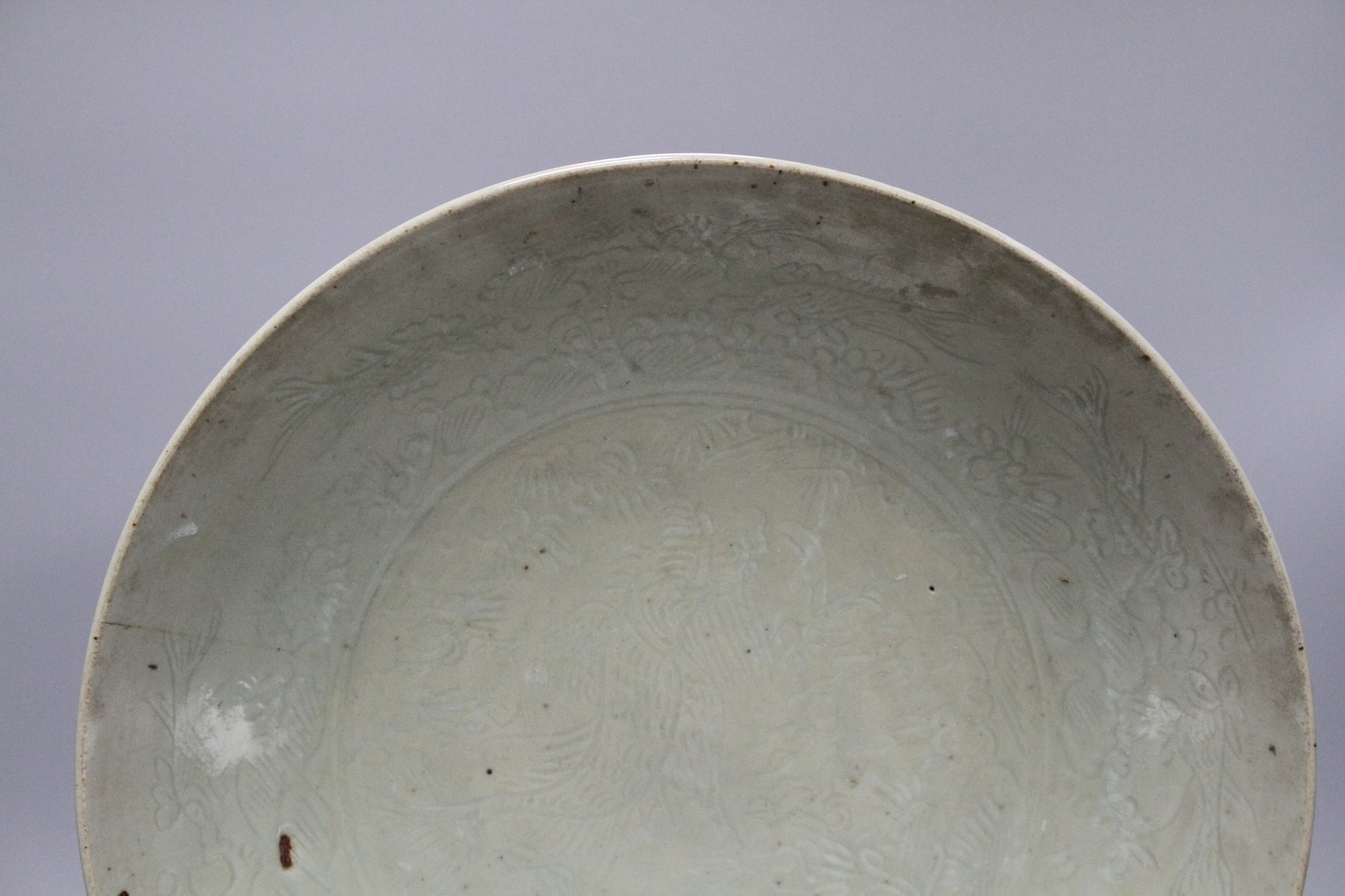A Chinese Ming celadon dish, Zhangzhou kilns, c.1580-1620, incised with fish and water plants, - Image 2 of 5