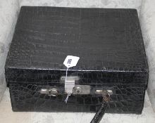 An early 20th century black crocodile toilet case, 40 x 33 x 18cm Condition: Handle detached,