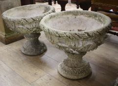 A pair of reconstituted stone garden urns, H.46cm Diam.53cm Condition: One cracked / repaired