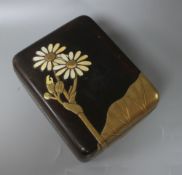 A Japanese Meiji period lacquer box, decorated with lotus leaves and flowers, with the petals