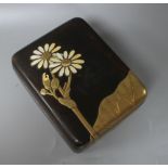 A Japanese Meiji period lacquer box, decorated with lotus leaves and flowers, with the petals