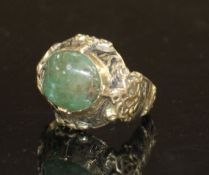 An antique yellow metal (tests as high carat), black enamel and cabochon emerald set ring, size G/H,