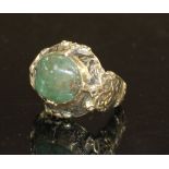 An antique yellow metal (tests as high carat), black enamel and cabochon emerald set ring, size G/H,