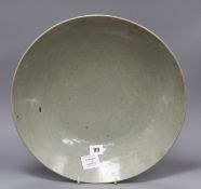 A Chinese Ming celadon dish, Zhangzhou kilns, c.1580-1620, incised with fish and water plants,