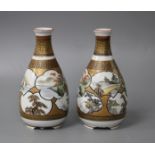 A pair of Kutani porcelain vases, decorated with landscape panels, signed to the underside, height