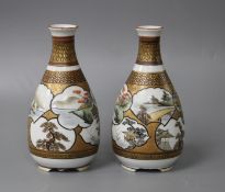 A pair of Kutani porcelain vases, decorated with landscape panels, signed to the underside, height