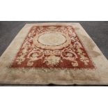 A Chinese terracotta ground carpet, 370 x 276cm Condition: Faded and dirty but no tears noted