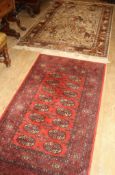 A Meshed machined wool rug, 190 x 126cm and a Bokhara machined rug, 170 x 83cm Condition: Both a