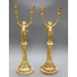 A pair of Italian gilt metal candelabra, with cherub stems and onyx bases, height 52cm Condition: