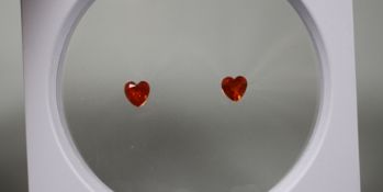 A near pair of unmounted heart shaped fire opals, each weighing approximately 0.90ct. Condition: