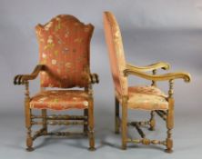 A pair of 19th century French 17th century style carved walnut high back armchairs, with floral