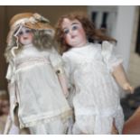 A German doll marked 62, original wig, fixed eyes and wrists, 14in., and a German doll marked 3002