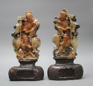 A pair of Chinese soapstone carvings depicting figures riding upon elephants, height 19cm, height