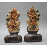 A pair of Chinese soapstone carvings depicting figures riding upon elephants, height 19cm, height