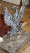 A cast iron spread eagle garden ornament with stone plinth base, W.52cm H.75cm Condition: Looks like
