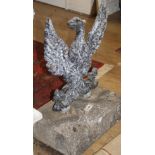 A cast iron spread eagle garden ornament with stone plinth base, W.52cm H.75cm Condition: Looks like