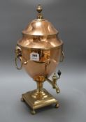 A Regency brass mounted copper tea urn, with ram's mask ring handles, height 51cm Condition: Fair