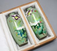 A pair of Japanese late Meiji period cloisonne vases, decorated with flowers on a celadon green