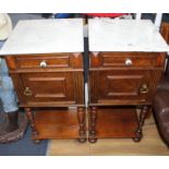 A pair of early 20th century French walnut bedside cupboards, with white marble tops, W.40cm D.