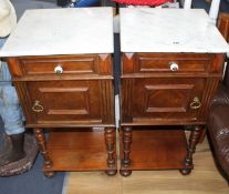 A pair of early 20th century French walnut bedside cupboards, with white marble tops, W.40cm D.