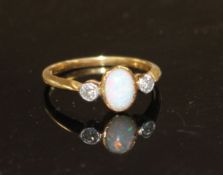 A mid 20th century 18ct and Pt, white opal and diamond three stone ring, size O/P, gross weight 2.