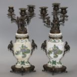 A pair of Samson famille verte style bronze mounted candelabra, with rustic branches and dragon