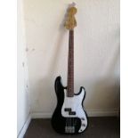 A Squier P-Bass guitar Condition: Electrics all working, some crackle to pots, some damage to body