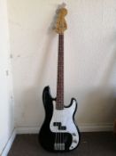 A Squier P-Bass guitar Condition: Electrics all working, some crackle to pots, some damage to body