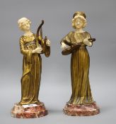 A pair of Alphonse Gori ivory and ormolu figures of medieval musicians, girl playing an Irish