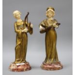 A pair of Alphonse Gori ivory and ormolu figures of medieval musicians, girl playing an Irish