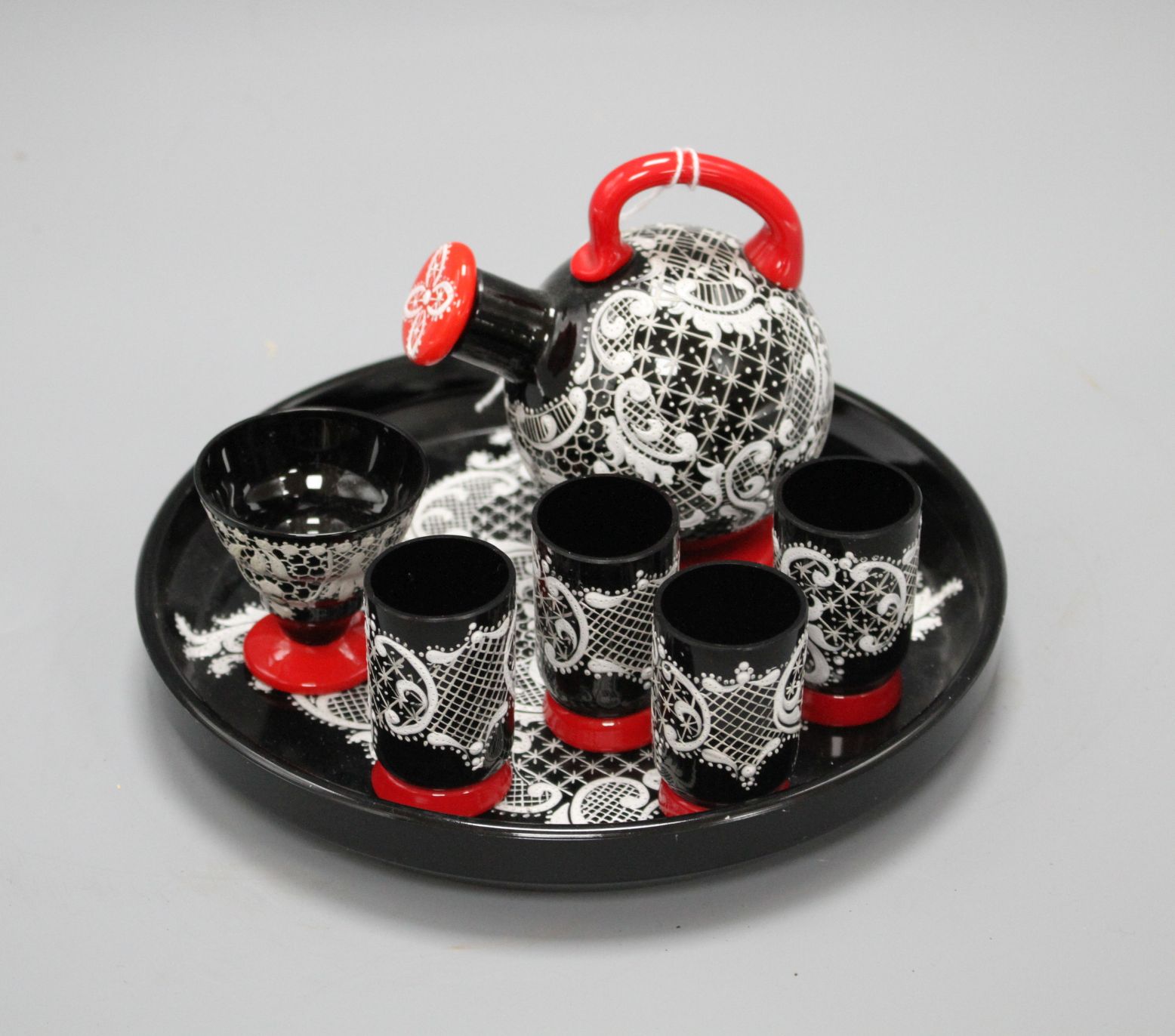 A Murano seven piece glass liqueur set, with lacework decoration, tray diameter 18cm Condition: