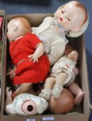 Four plastic and composition dolls