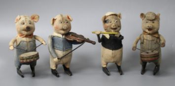 A set of four Schuco clockwork tinplate musical pigs, height 11cm Condition: All costumes faded