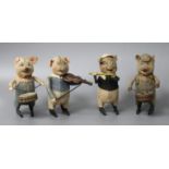 A set of four Schuco clockwork tinplate musical pigs, height 11cm Condition: All costumes faded