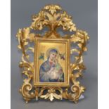 A Continental porcelain icon depicting Madonna and Child, in a Florentine frameCONDITION: Two pieces